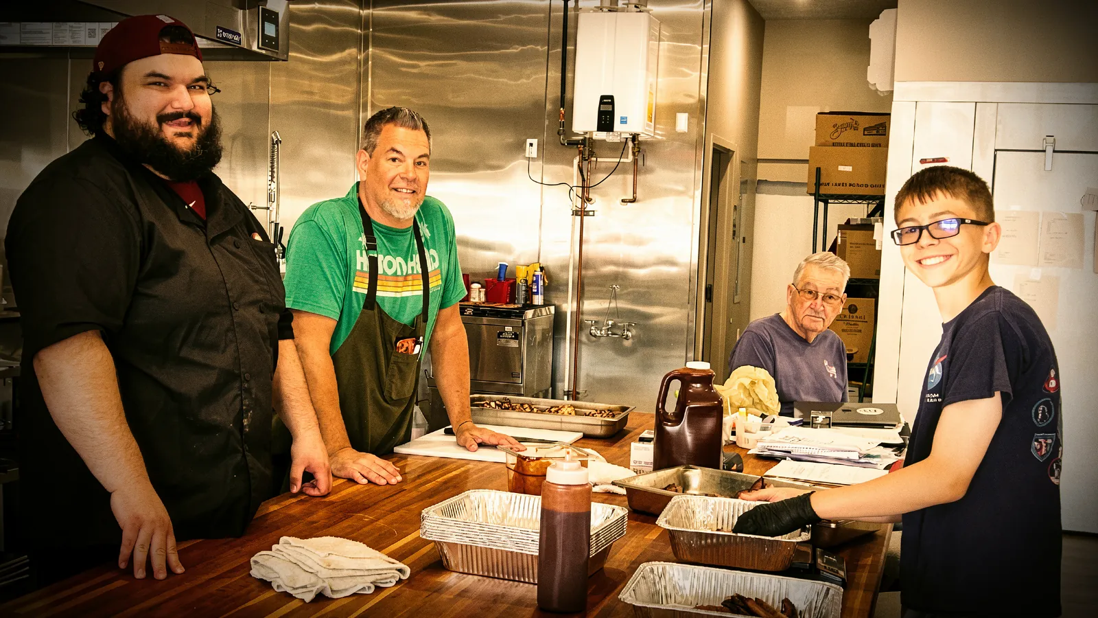 Three generations plating a family barbecue together