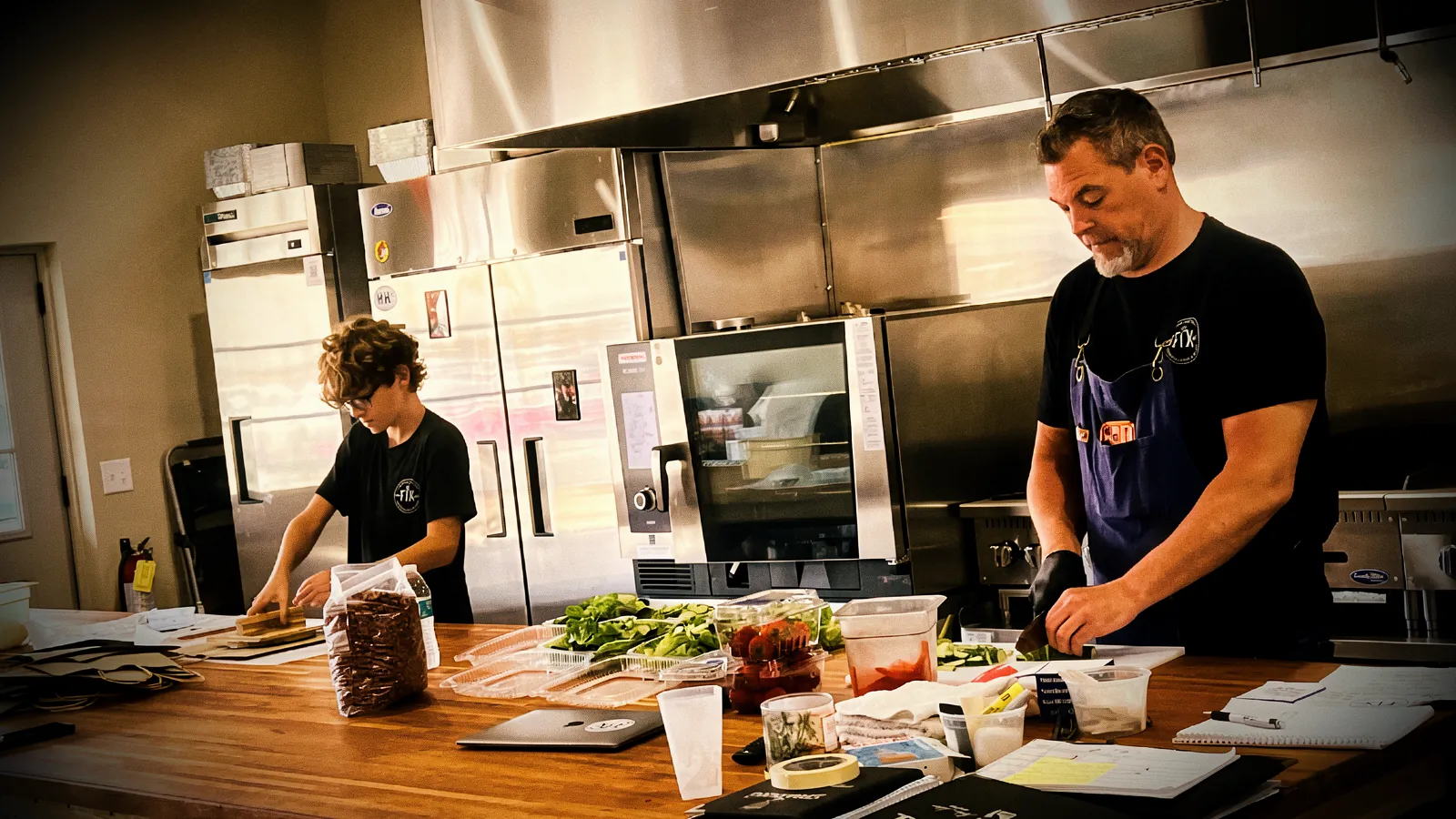 Chef T and his son at work in the commercial kitchen