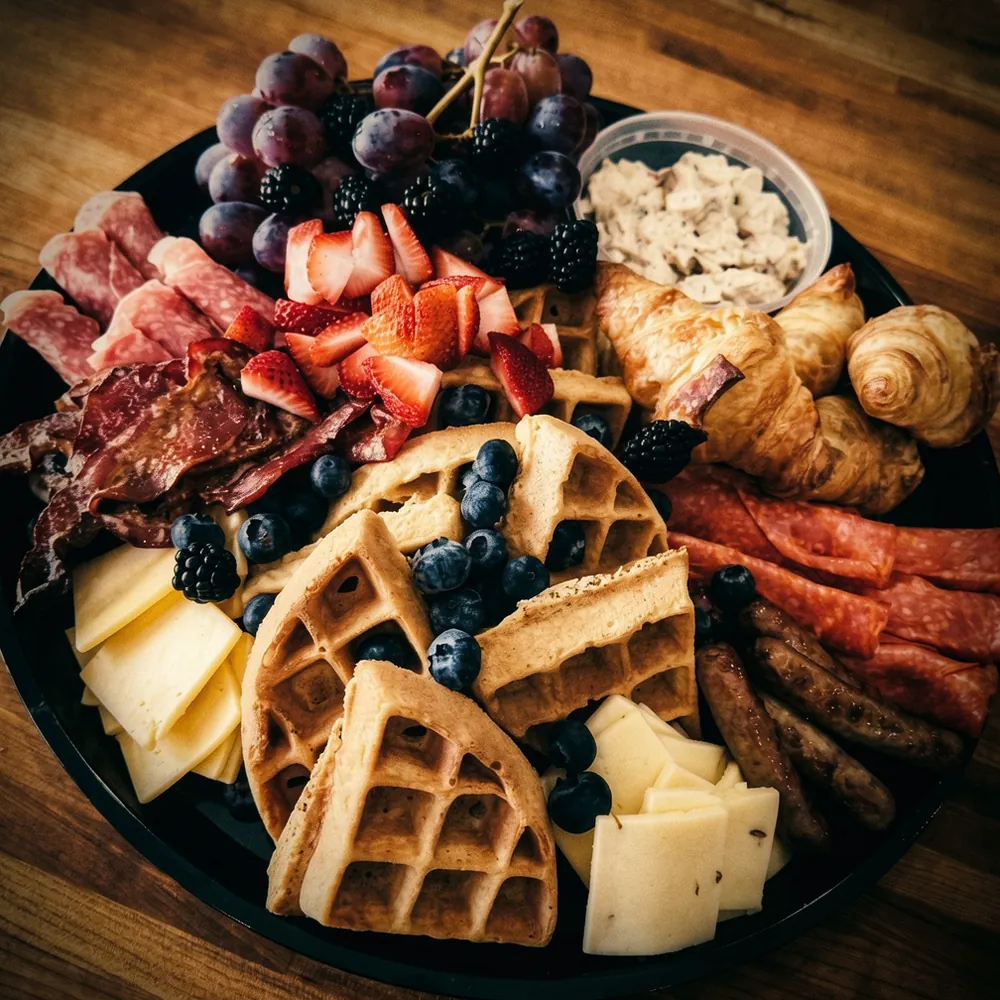 Close-up of a breakfast platter with waffles and berries