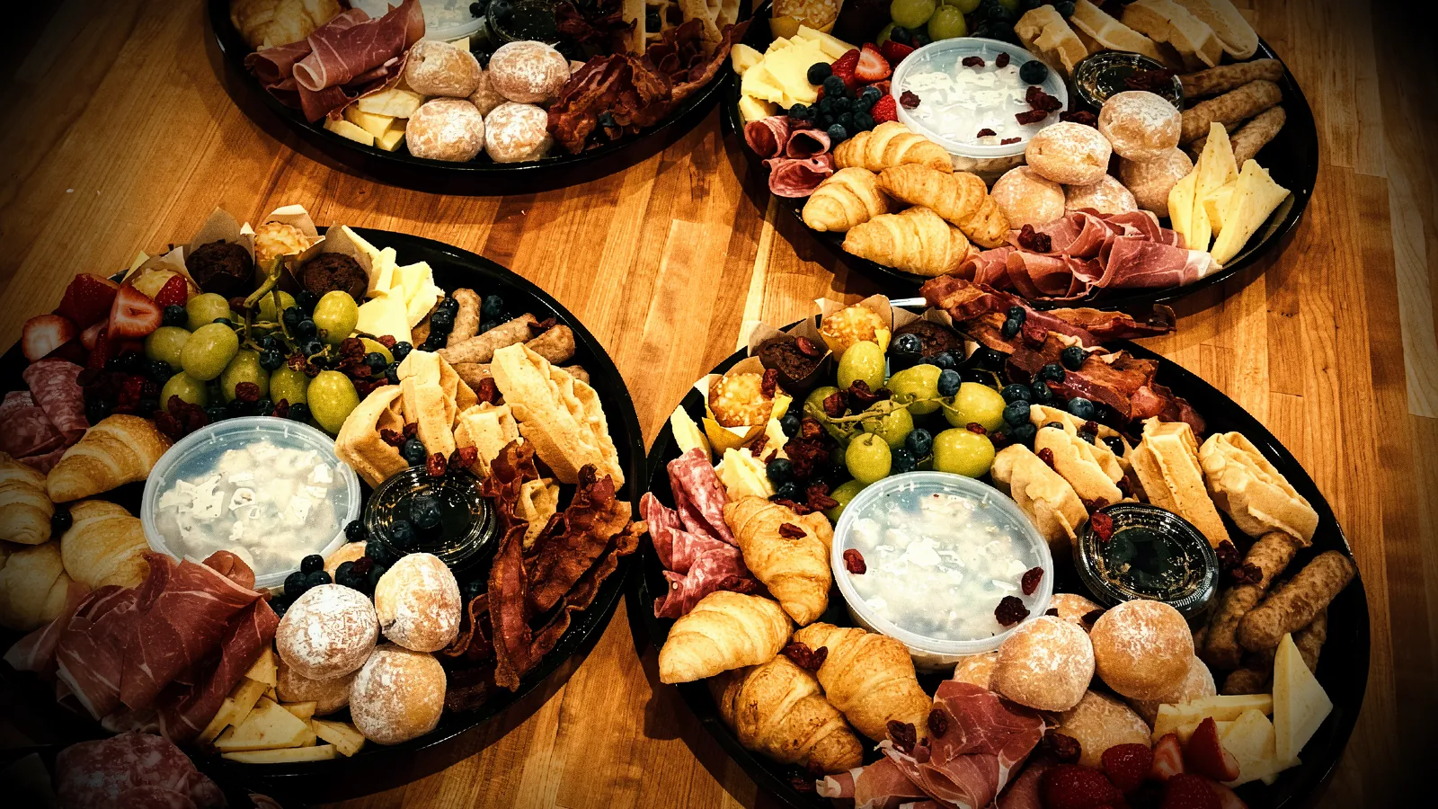 A line of breakfast platters prepared for a catering order