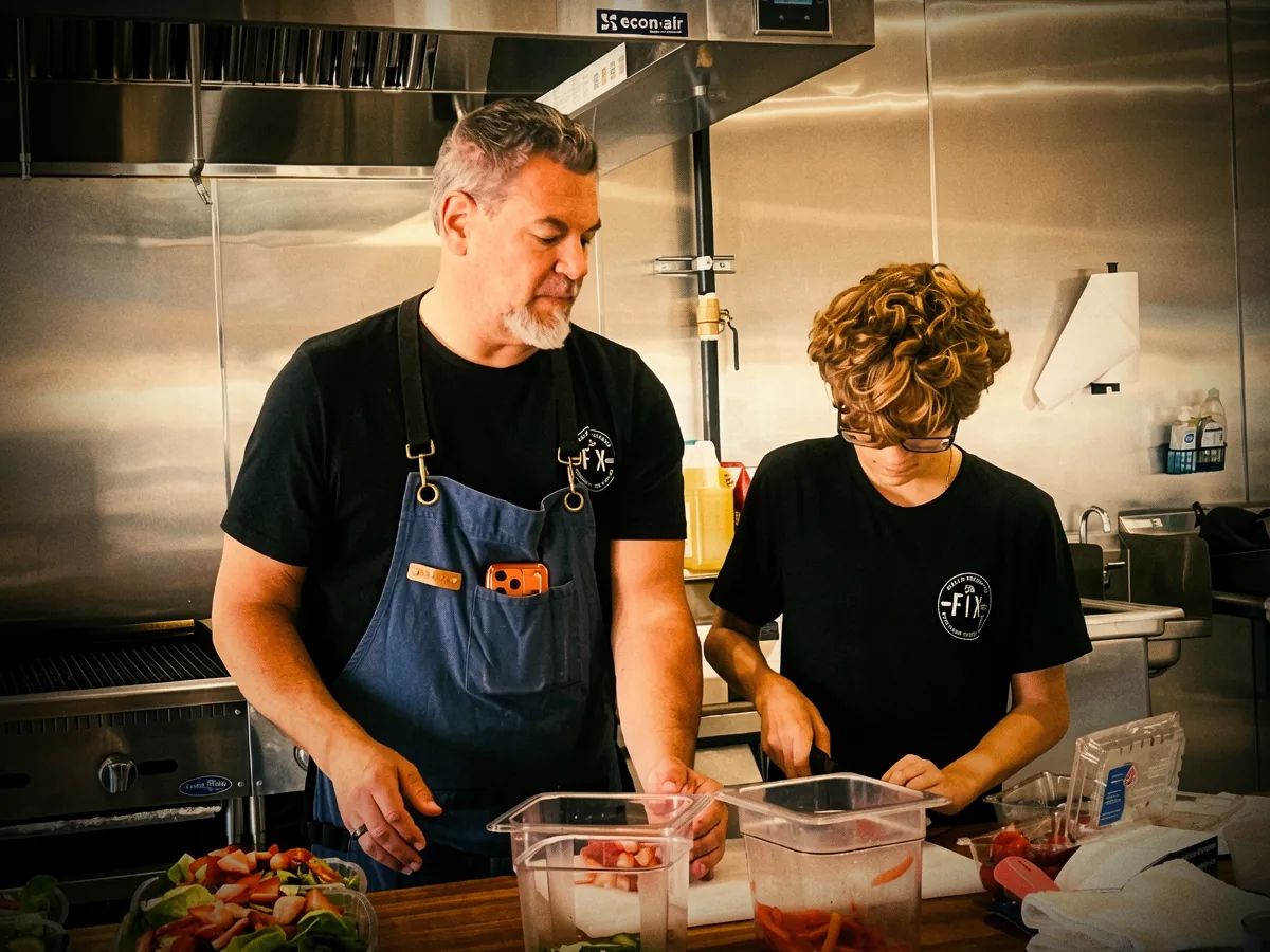 Chef T and his son prepping fresh berry salads in the kitchen